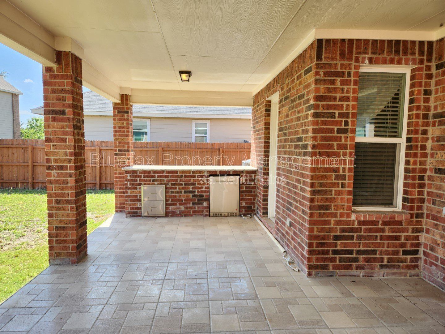 HUGE Covered Patio with Built In Counters, a Refrigerator and a Place for Your Grill! property image